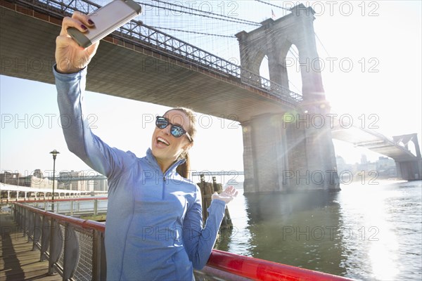 Caucasian woman taking selfie on waterfront