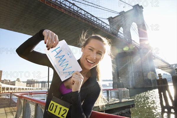 Caucasian runner holding race sign