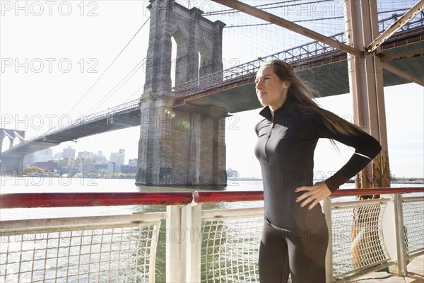 Caucasian runner standing on waterfront