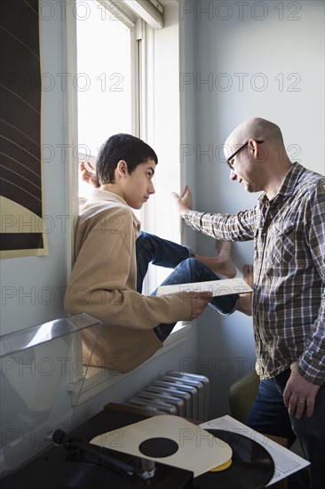 Father and son listening to records