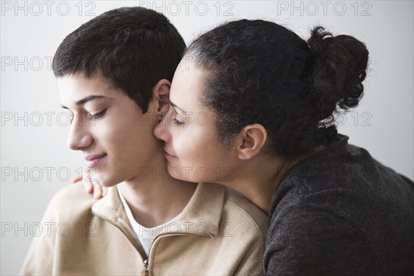 Close up of mother hugging son