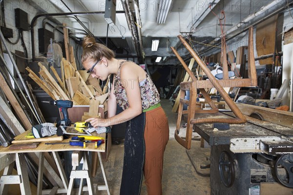 Caucasian woman using digital tablet in workshop