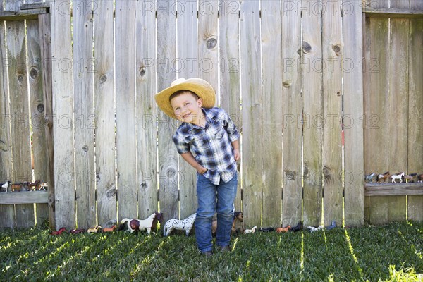 Caucasian boy wearing cowboy hat smiling