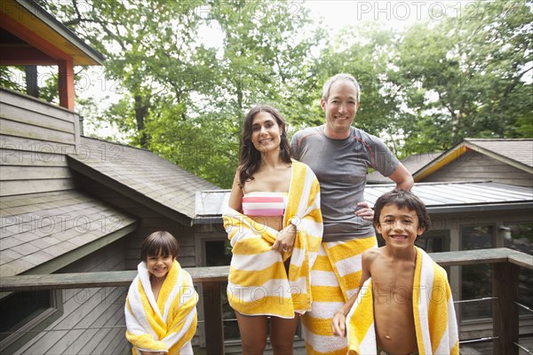 Smiling family wrapped in towels
