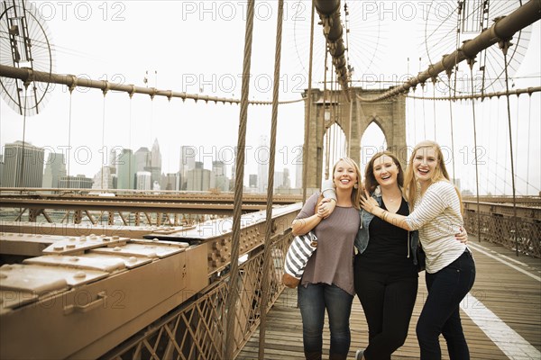Portrait of smiling Caucasian women posing on bridge