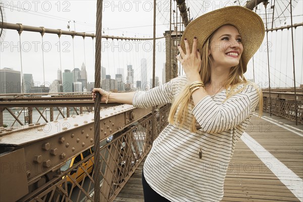 Portrait of smiling Caucasian woman on bridge