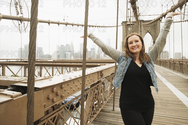 Portrait of smiling Caucasian woman on bridge