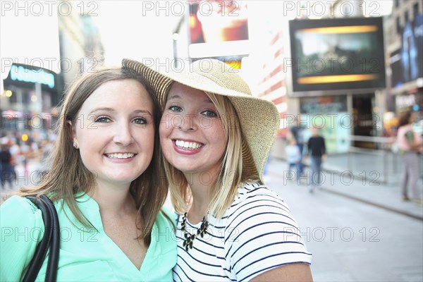 Portrait of smiling Caucasian women posing in city