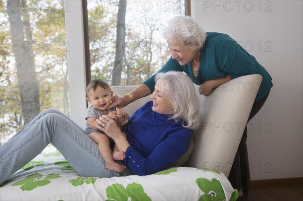 Grandmothers playing with baby grandson