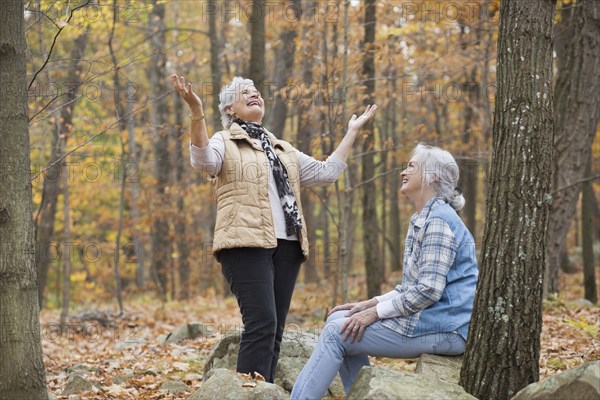 Caucasian women smiling outdoors in autumn