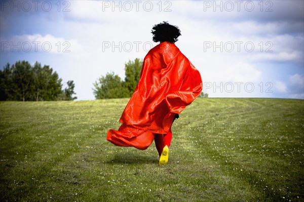Asian woman running in field