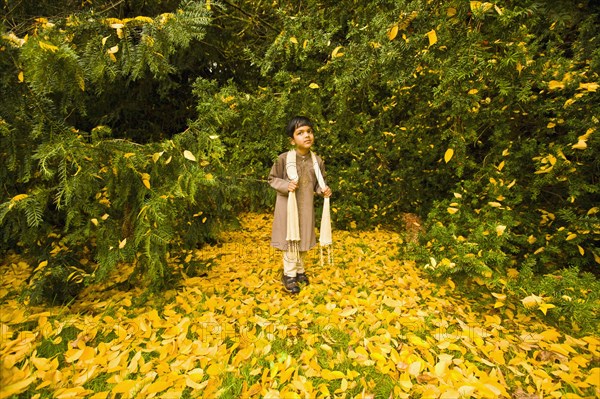 Indian boy in front of trees