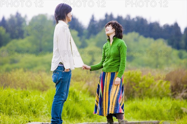 Asian couple smiling at each other