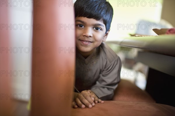 Indian boy laying on floor