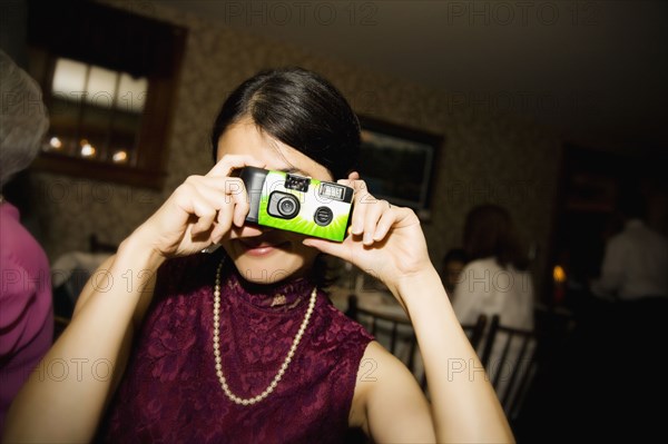 Asian woman taking photograph