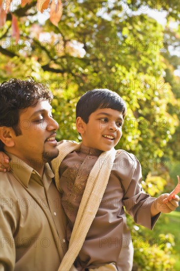 Indian father holding son