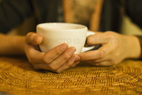 Close up of woman's hands holding tea mug