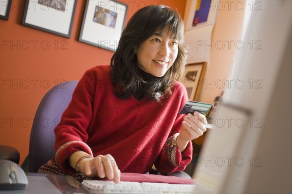 Asian woman shopping online