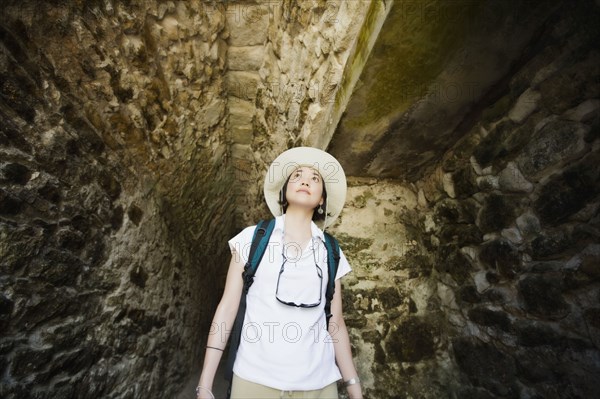 Asian woman walking in tunnel