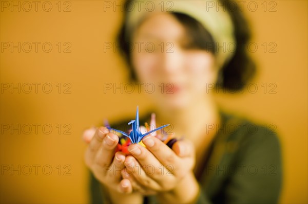 Japanese woman holding origami bird