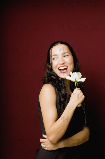 Hispanic woman posing with white rose