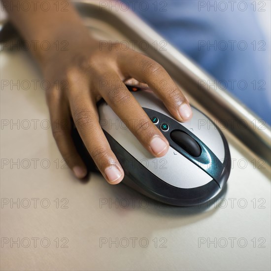 African girl's hand on computer mouse