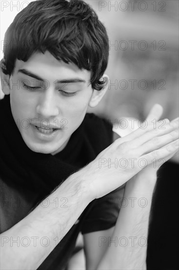 Mixed race man with hands clasped