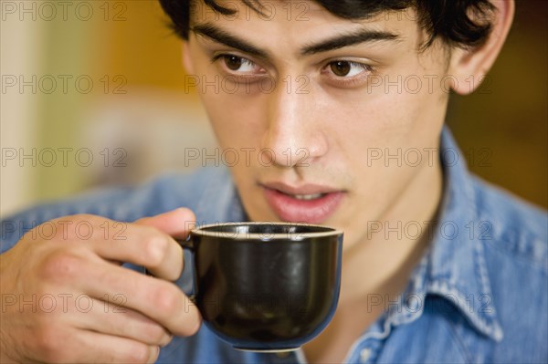 Mixed race man drinking coffee