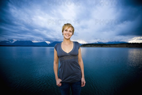 Caucasian woman standing near lake