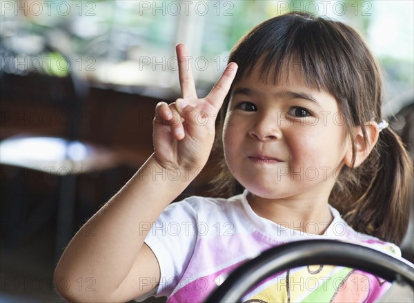 Asian girl making peace sign