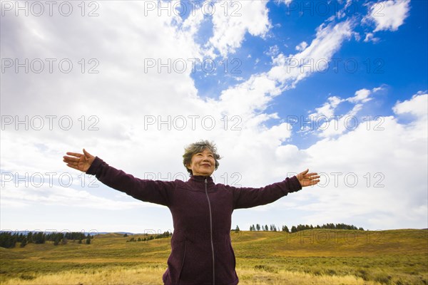 Japanese woman standing in rural landscape