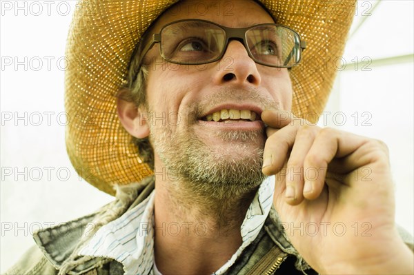 Caucasian farmer wearing straw hat outdoors