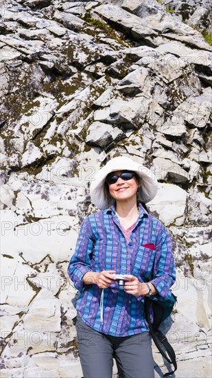 Japanese tourist photographing rock formation