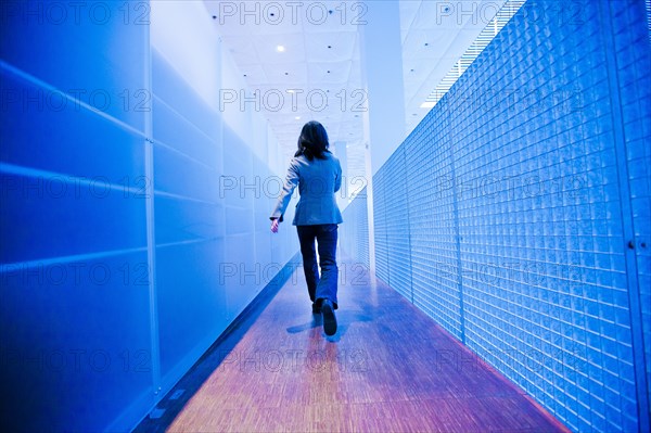 Japanese businesswoman walking in hallway