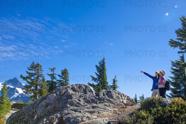 Japanese mother and daughter admiring mountain