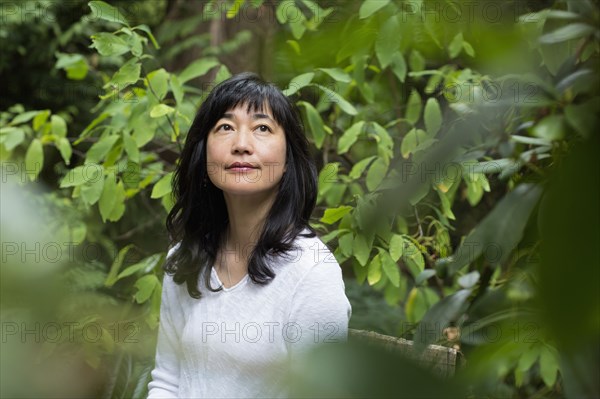 Japanese woman sitting in garden