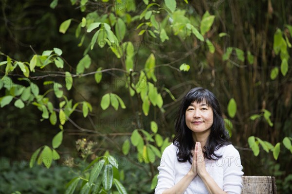 Japanese woman meditating in garden