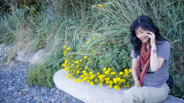 Japanese woman talking on cell phone outdoors