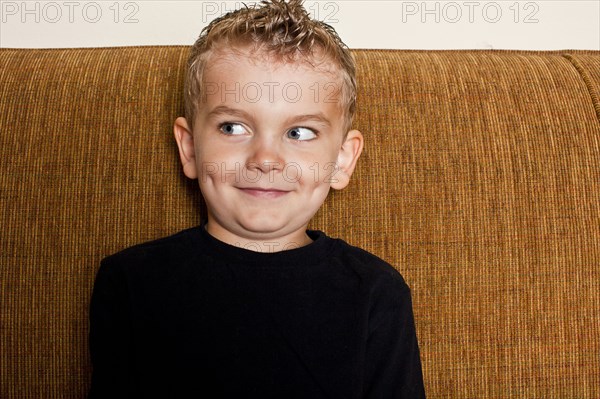 Caucasian boy sitting on sofa