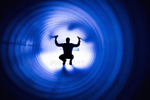 Silhouette of Caucasian man in tunnel