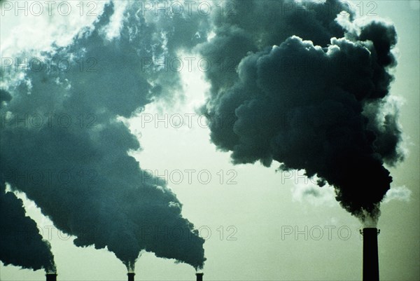 Smoke billowing from industrial smoke stacks