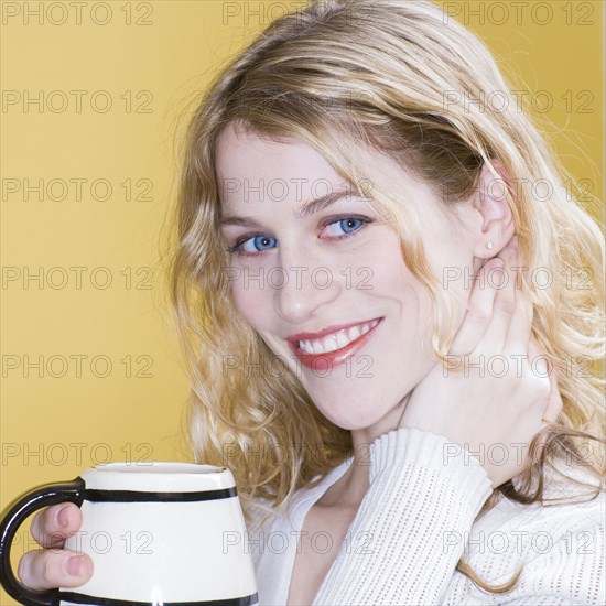 Smiling woman drinking cup of coffee