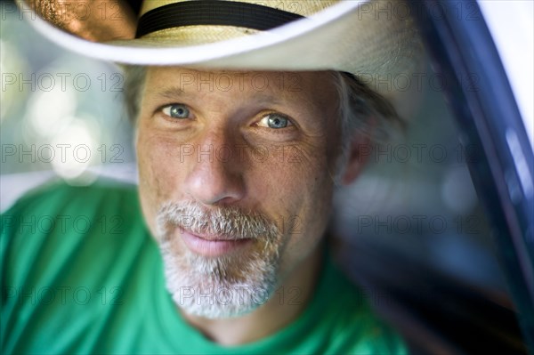 Smiling man wearing cowboy hat