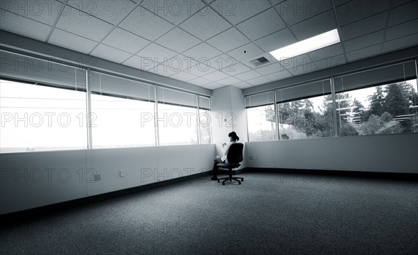 Japanese businesswoman sitting in corner of empty office