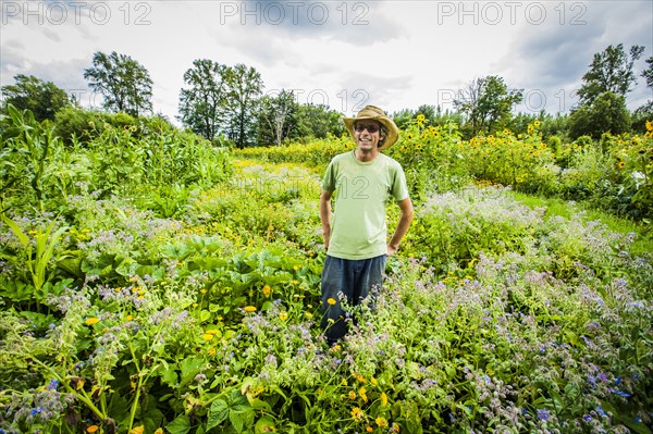 Caucasian farmer wearing cowboy hat in field