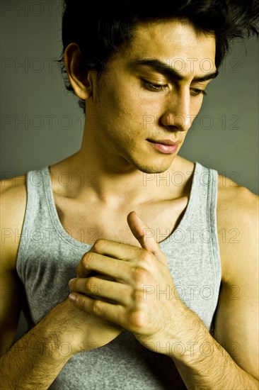 Pensive Mixed Race man wearing tank-top