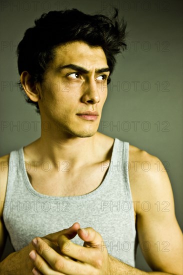 Pensive Mixed Race man wearing tank-top