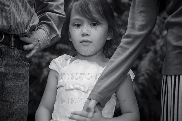 Serious girl posing with mother and father