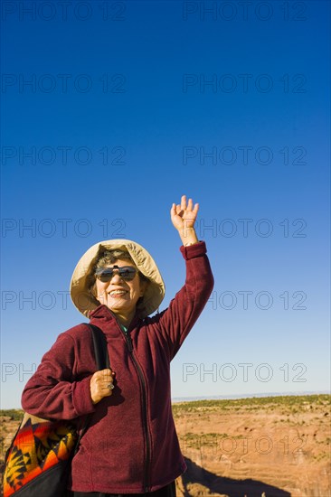 Japanese woman waving outdoors