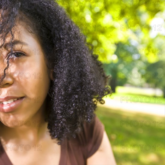 Smiling Mixed Race woman in park